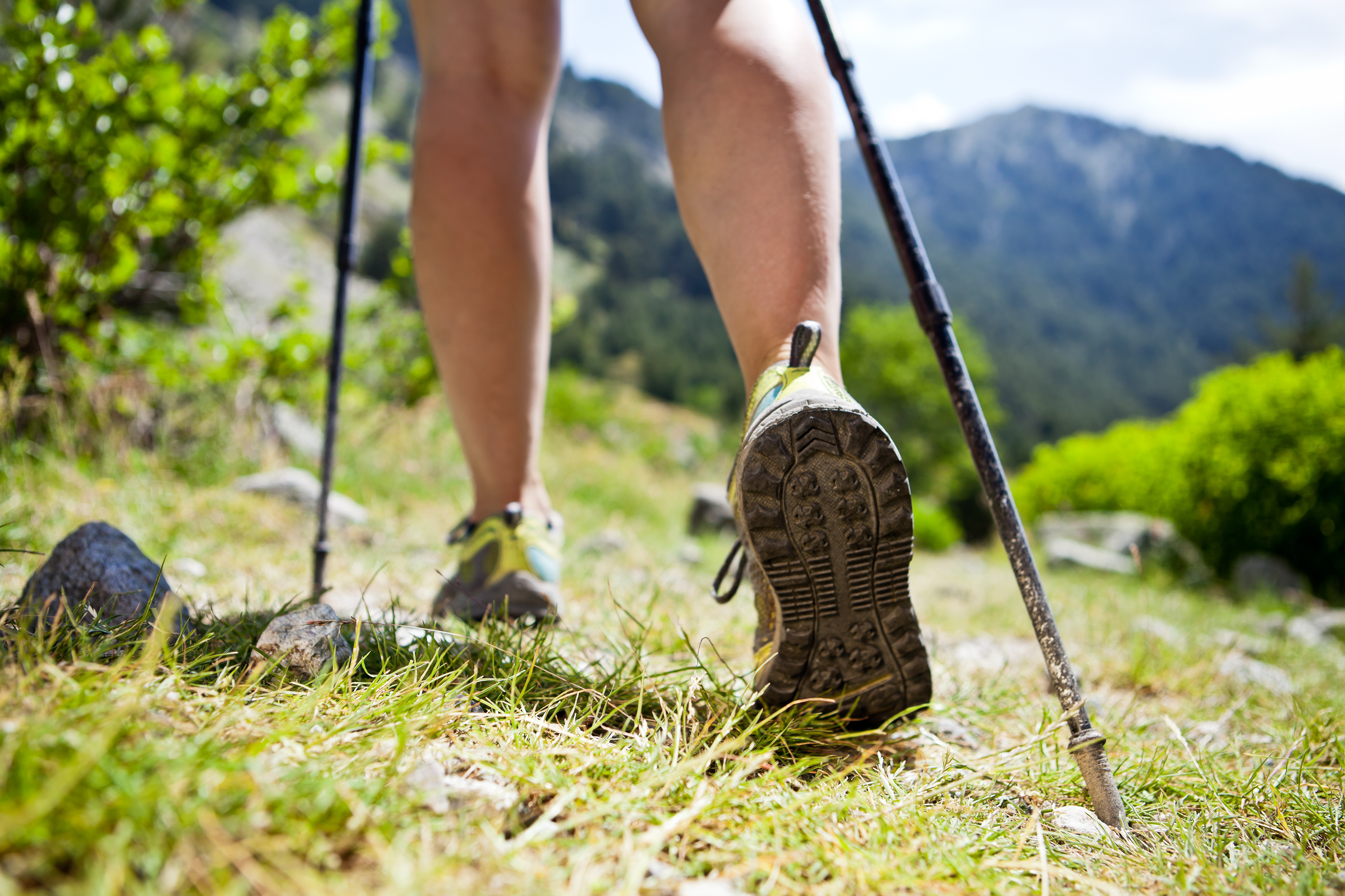 Woman hiking in mountains, adventure and exercising